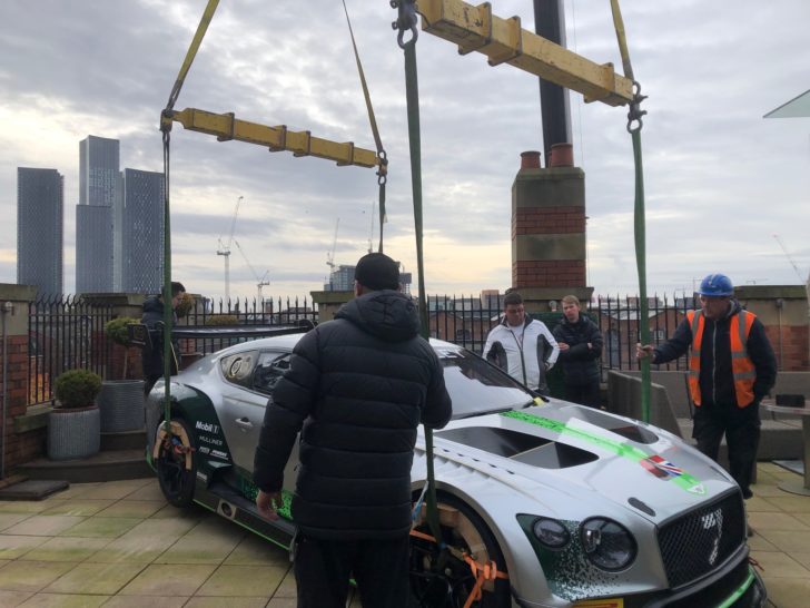 Lifting a bentley sports car onto a rooftop terrace of a manchester hotel as part of bentleys 100 year celebrations.