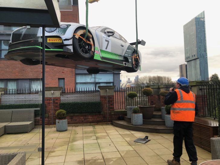 Lifting a bentley sports car onto a rooftop terrace of a manchester hotel as part of bentleys 100 year celebrations.